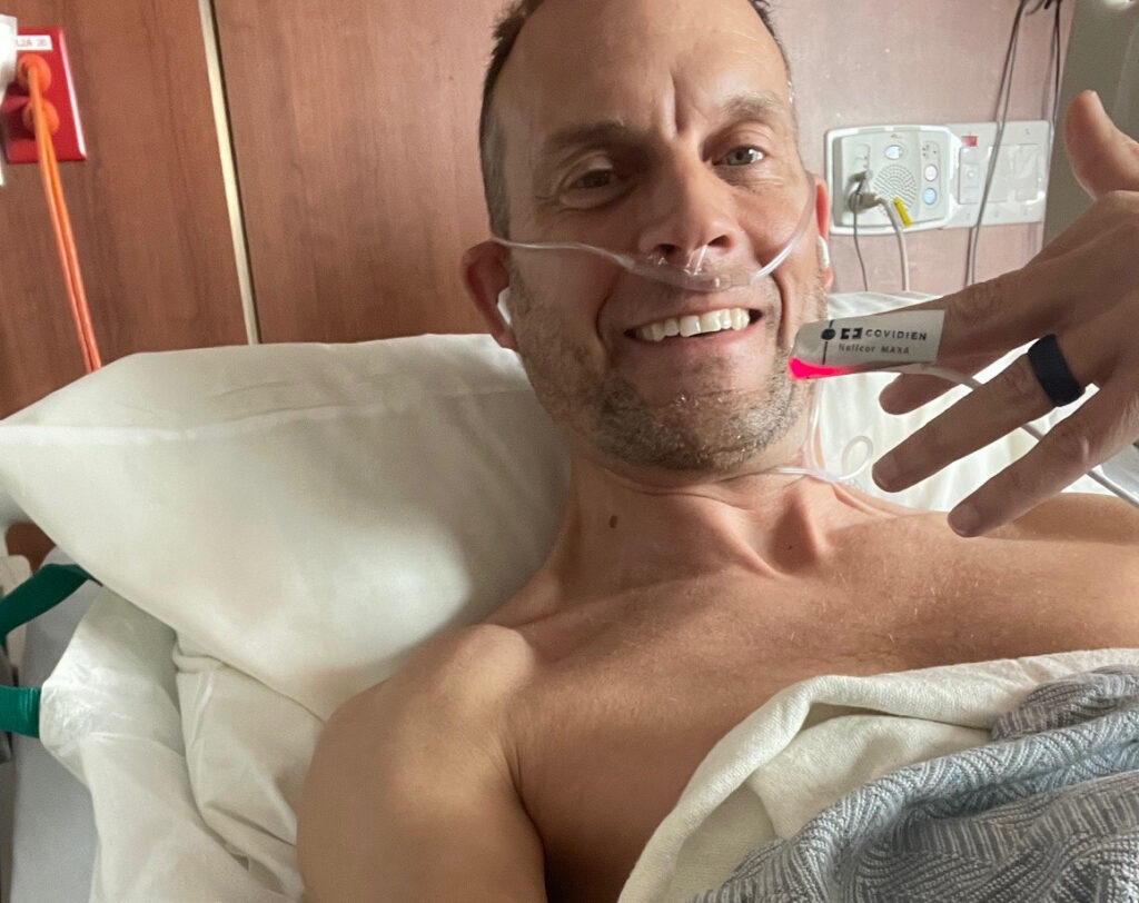 Mark in a hospital bed.